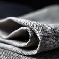 Close-up view of textured fabric in a neutral tone with folds photo