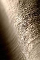 Textured fabric shows intricate weave and subtle light play photo