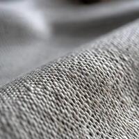 Close-up view of textured fabric background displaying intricate weave photo