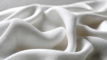 Soft white fabric draped elegantly in natural light photo