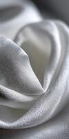 Elegant white silk fabric draped in soft folds highlights texture photo