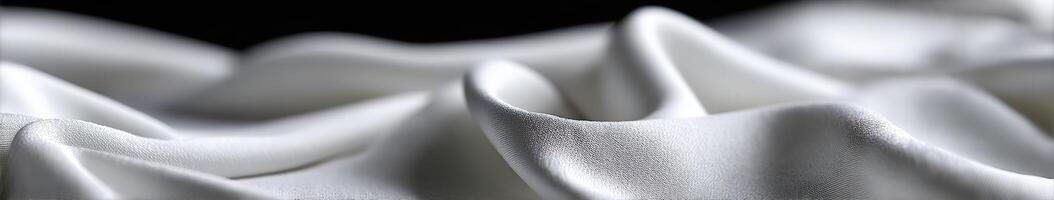 Flowing white fabric drapes elegantly against a dark background photo