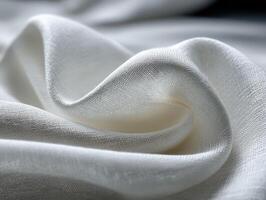 Soft white fabric with gentle folds in a textured background photo