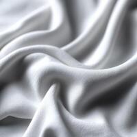 Soft white fabric draped elegantly on a smooth surface photo
