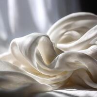 Soft white fabric drapes elegantly in natural light photo