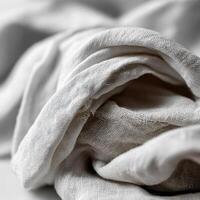 Soft textured fabric draped elegantly on a neutral background photo