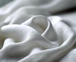 Soft white fabric draped artistically on a smooth surface photo