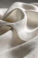 Soft white fabric draping gracefully on a smooth surface photo