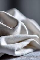 Soft white fabric draped elegantly on a surface photo