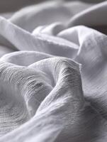 Soft, textured white fabric draping over a flat surface photo