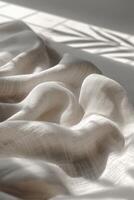 Soft fabric draped elegantly on a sunlit surface photo