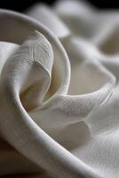 Soft white fabric draping elegantly on a dark background photo