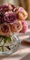 Elegant roses in a glass vase on a soft table photo