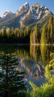 Majestic mountains reflect in tranquil lake at sunrise photo