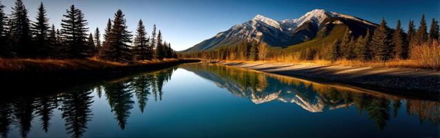 Serene river reflecting majestic mountains at sunrise photo