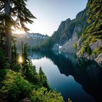 Serene mountain lake reflecting sunlight at dawn photo