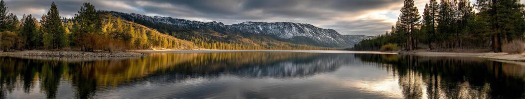 Serene lake view surrounded by mountains and forests photo
