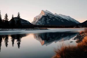 Reflections of mountains in serene waters at dusk photo