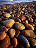 Colorful pebbles along a serene beach coastline photo