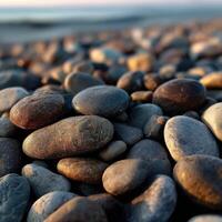 Colorful pebbles on a beach at sunset photo