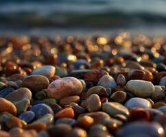 Colorful pebbles glistening on the shore at sunset photo