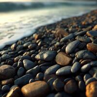 Smooth pebbles along a tranquil beach at sunset photo