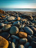 Pebbles on a tranquil beach during sunset photo