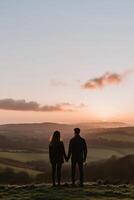 Couple enjoys sunset view over rolling hills photo