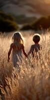 Children explore golden grass field at sunset photo