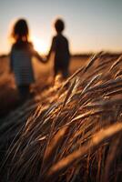 Children enjoy sunset while holding hands in a field photo
