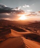 Stunning sunset over vast sand dunes photo