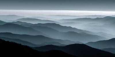 Misty mountain landscape with layered hills in twilight photo