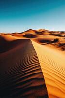 Desert landscape with golden sand dunes under clear sky photo