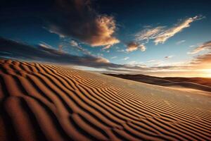Desert landscape at sunset with rippled sand dunes photo