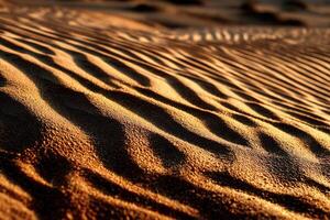 Textured patterns of golden desert sand at sunset photo