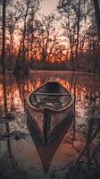Canoe resting peacefully on still water at sunset photo