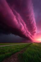 Stunning purple clouds hover over green fields at dusk photo
