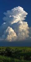Majestic cloud formation over green fields in daylight photo