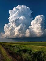 Dramatic clouds gather over green fields in summer sky photo