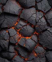 A close up of a black lava rock with orange flames photo