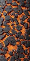 A close up of a black and orange surface photo