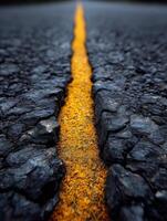 A long road with a yellow line on the side photo