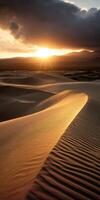 The sun is setting over the sand dunes photo
