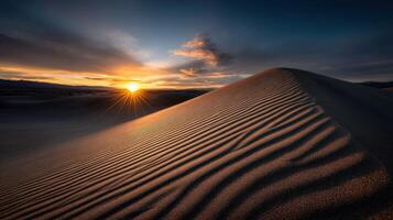 The sun sets over the sand dunes in death valley photo