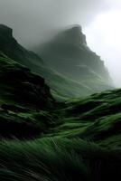 A green grassy hillside with mountains in the background photo