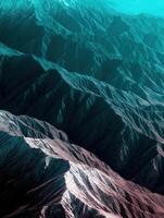An aerial view of mountains with blue and pink colors photo