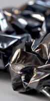 A pile of black plastic bags on a table photo