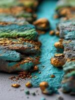 A close up of a piece of rock with gold and green paint photo