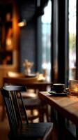 A table with a cup of coffee and a candle on it photo