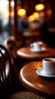 A coffee cup and saucer sitting on a table photo